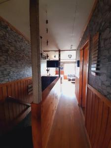 a hallway of a house with a stone wall at Cabaña León in Puerto Natales