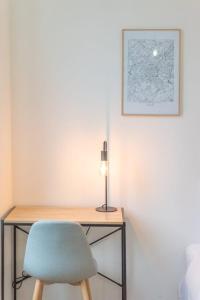 un escritorio con una silla y una lámpara. en Lille Centre - Nice & functional studio en Lille