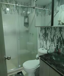 y baño con aseo, ducha y lavamanos. en GURUS FR | Elegante Apartamento en parque acuático Dosquebradas, en Dosquebradas