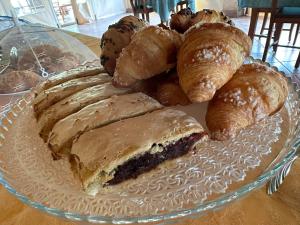 a plate of pastries and croissants on a table at Il Nibbio Reale Country House in Rocca dʼEvandro