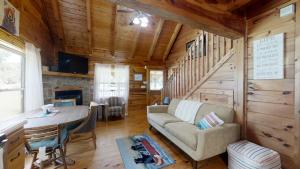 a living room with a couch and a table in a cabin at Yellow Cabin on the River in Newport