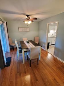 a dining room with a table and chairs and a ceiling fan at Andrea Abode in Lexington