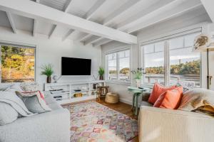 a living room with two couches and a tv at Cozy Cottage on the Penobscot — Panoramic Luxury! 