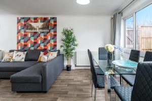 een woonkamer met een bank en een tafel bij Skyvillion-STEVENAGE Amazing 3Bed House, Garden, Free Off Street Parking for 2 Cars, WiFi in Stevenage