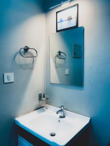 a bathroom with a white sink and a mirror at His grace villas in Kottakkal
