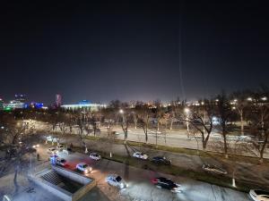 um estacionamento com carros numa cidade à noite em APARTMENT «СЕМЬЯ» em Tashkent