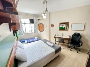 1 dormitorio con 1 cama y escritorio con silla en Solar do Flamengo 3min Aterro/praia 250 m do metrô en Río de Janeiro