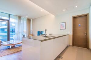 a kitchen with a sink and a table at Cityscape lofts Living in City Walk 2BR Unit in Dubai