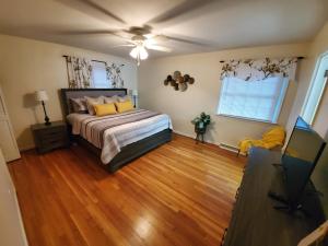 a bedroom with a bed and a flat screen tv at Andrea Abode in Lexington