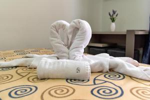 uma pilha de toalhas sentadas em cima de uma cama em Pensiunea Diadis em Cluj-Napoca