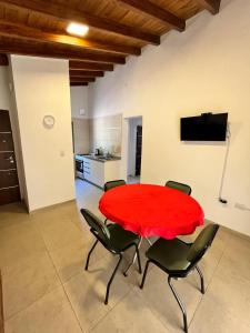 a red table and chairs in a living room at Villa Simona in Santa Rosa de Calamuchita +18 photos