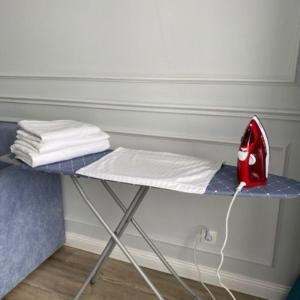 a iron sitting on a table next to a bed at Highvill Ishim 412 in Astana