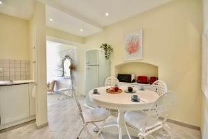 a kitchen and dining room with a white table and chairs at Gramsci 79 - Beachfront in Santa Margherita Ligure