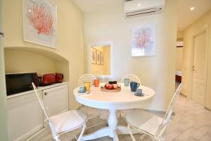 a dining room with a white table and chairs at Gramsci 79 - Beachfront in Santa Margherita Ligure +32 photos