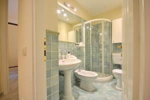 a bathroom with a sink and a toilet and a mirror at Gramsci 79 - Beachfront in Santa Margherita Ligure