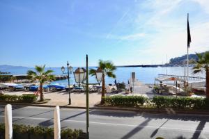 a view of a marina with palm trees and the water at Gramsci 79 - Beachfront in Santa Margherita Ligure