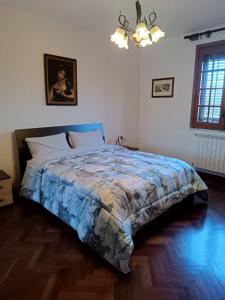 a bedroom with a bed with a blue comforter at Casa Belvedere in Isnello