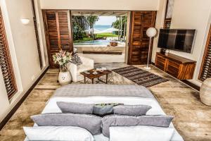 a living room with a large bed and a television at Hidden All inclusive House in Punta Mita in Punta Mita