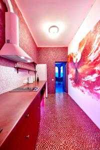 a kitchen with red walls and a red floor at Domeparty - лучшая локация для вечеринок in Petropavlovskaya Borshchagovka