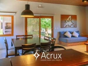 a living room with a table and chairs and a couch at Casas Acrux in Nono