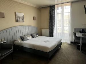 Ένα ή περισσότερα κρεβάτια σε δωμάτιο στο Cit'Hotel le Challonge