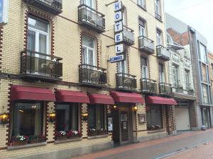 a building with a hotel sign on a street at Hotel Du Commerce in Blankenberge