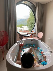 a child laying in a bath tub in a room at Del Trópico sopetrán in Sopetran