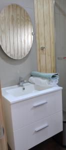 a bathroom with a white sink and a mirror at Cabaña Los Maquis en Castro in Castro +12 photos