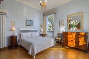 a bedroom with a bed and a dresser and a mirror at Villa Pedone in Lucca +101 photos