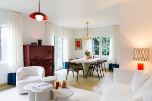 a living room with a white couch and a table at Villa Westland in Koksijde
