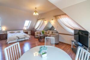 a bedroom and living room with a bed and a table at Apartament Pod Tatrami in Biały Dunajec