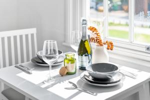a table with two glasses and a bottle of wine at Fabulous Apartment Overlooking Canal - Parking - Perry Barr - WIFI - Netflix - 3PB in Birmingham
