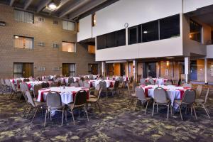 a banquet hall with tables and chairs in a building at Best Western Plus Kelly Inn in Saint Cloud