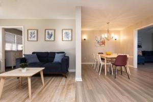 a living room and dining room with a couch and a table at Rejuvenation and Relaxation in Virginia Beach