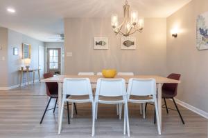 a dining room with a table and chairs at Rejuvenation and Relaxation in Virginia Beach +24 photos