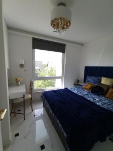 a bedroom with a bed and a desk and a window at Luxury Penthouse with Large Terrace & Panoramic Old Town View in Vilnius