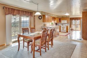 a dining room with a table and chairs and a kitchen at Charming Dundee Vacation Rental Near Hiking! in Dundee