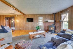 a living room with a couch and a fireplace at Charming Dundee Vacation Rental Near Hiking! in Dundee
