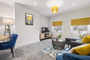 a living room with a couch and a tv at WhiskAwayStays - Victoria House - Apartment 5 in Worcester