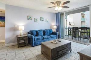 a living room with a blue couch and a table at Salt Pond Hideaway 133 by Brightwild in Key West