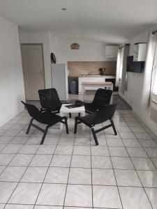 a living room with two chairs and a table at Résidence Les Hauts de France in Noeux-les-Mines