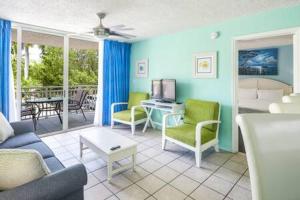 a living room with a couch and chairs at The Trinidad by Brightwild-Pool & Parking in Key West