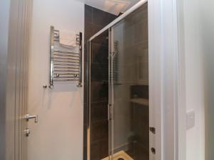 a bathroom with a shower with a glass door at Eboracum in Hathersage +22 photos