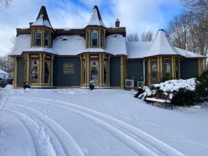 a house with a snow covered driveway in front of it at Belle View Manor Inn in Harbour Grace