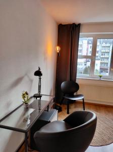 uma sala de estar com uma mesa de vidro e uma cadeira em MY HOME Studio, kitchen, WIFI em Chemnitz