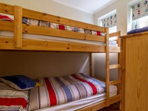 two bunk beds in a room with a bed at 2 bed in Syderstone KT197 in Syderstone