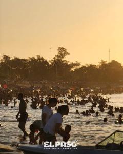 a group of people in the water at a beach at RINCON SOÑADO in Paso de la Patria