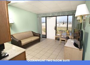 a living room with a couch and a room with a balcony at The Schooner Inn in Virginia Beach