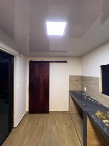 an empty room with a door and a wooden table at Container Home Py in Puerto Presidente Franco +26 photos