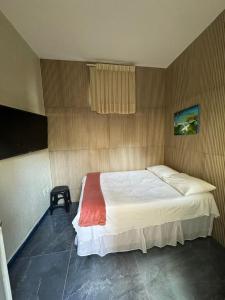 a bedroom with a large bed in a room at Pousada da Celma in Fortaleza